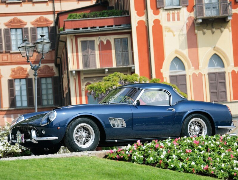 Blue Ferrari in front of a building