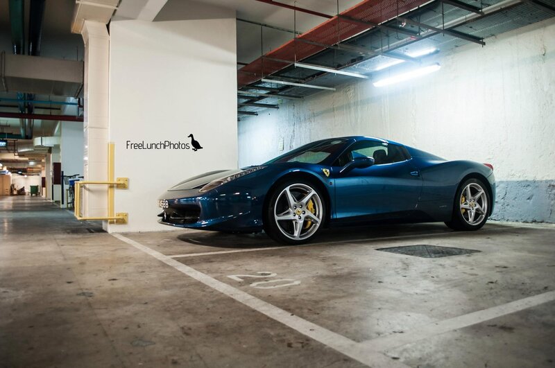 Blue Ferrari in parking garage
