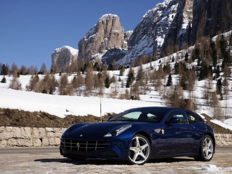 Blue Ferrari in snowy mountains