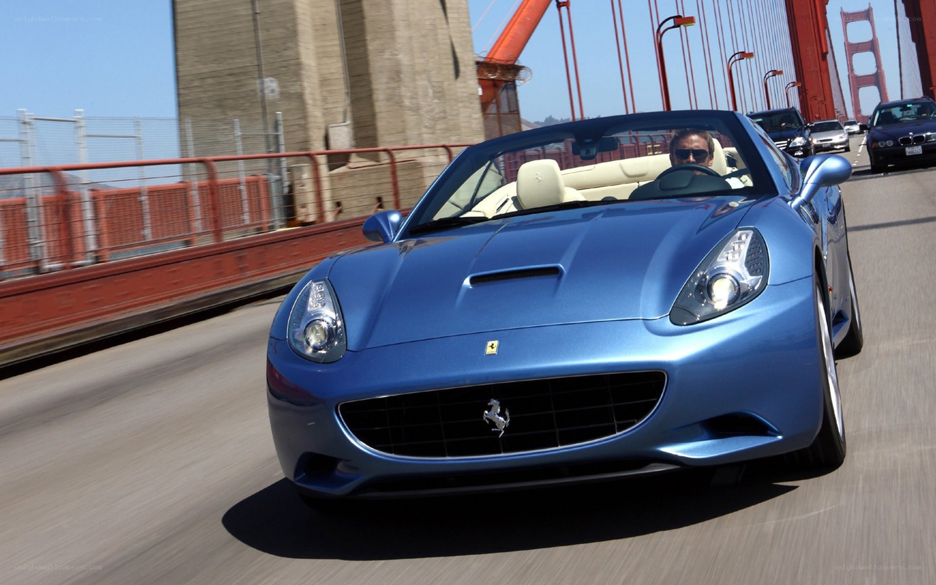 Blue Ferrari on a bridge