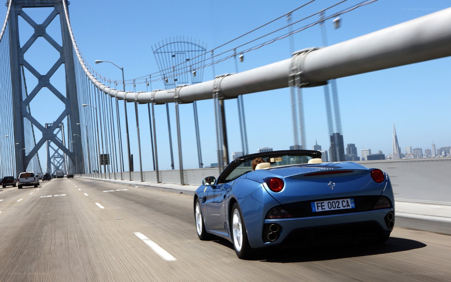 Blue Ferrari on a bridge