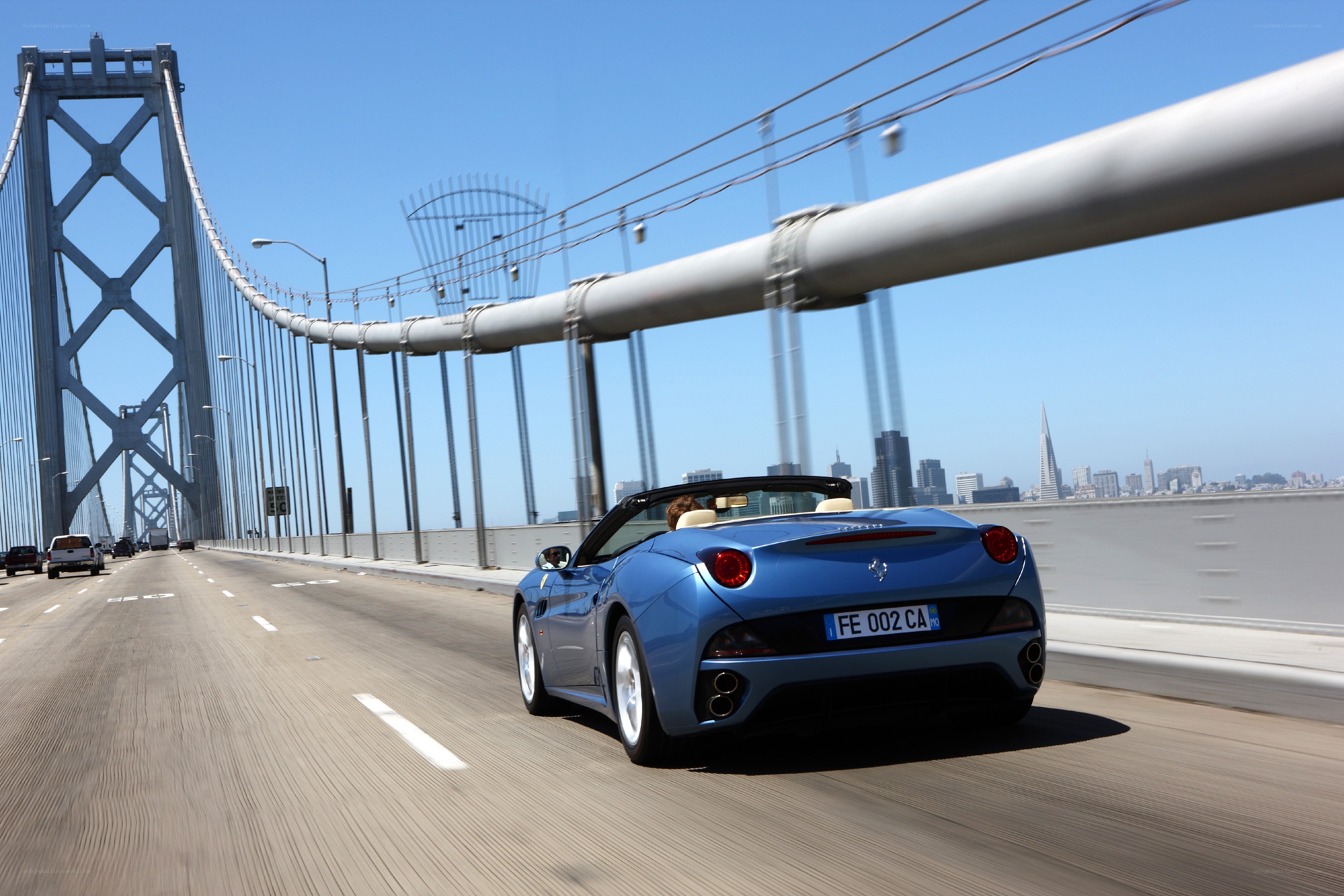 Blue Ferrari on a bridge