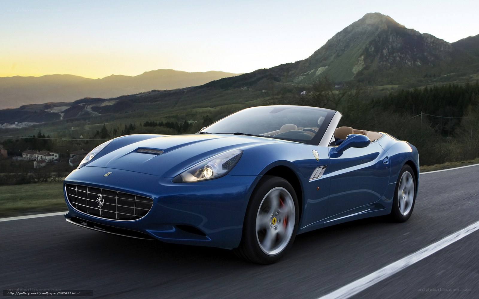 Blue Ferrari on a mountain road