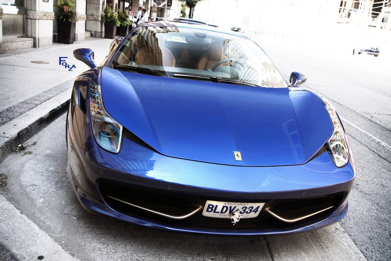 Blue Ferrari on city street