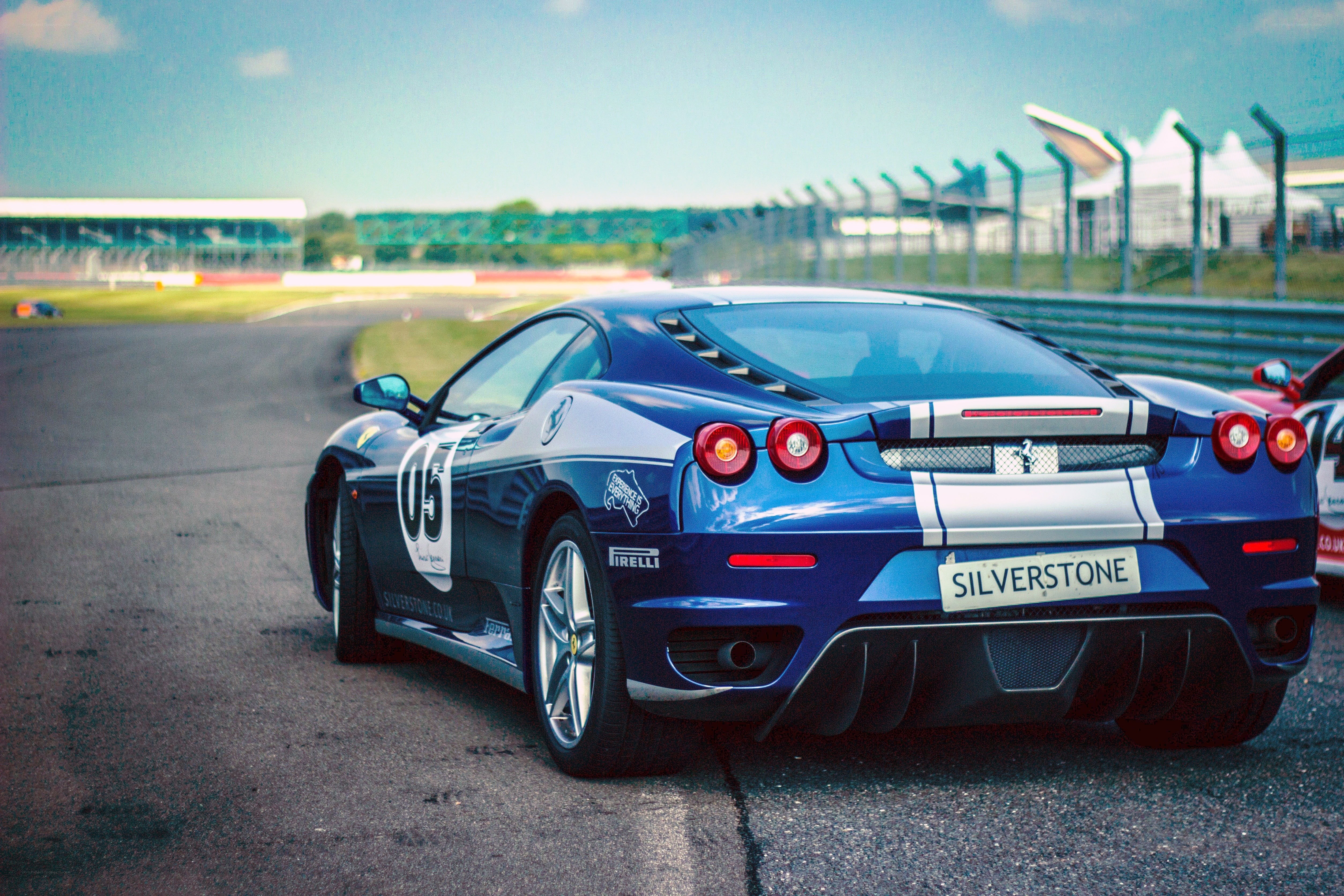 blue ferrari on racetrack