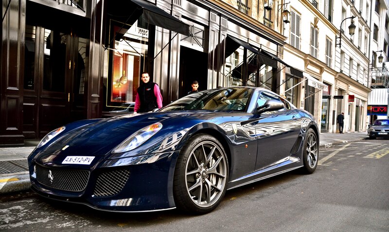 Blue Ferrari parked on city street