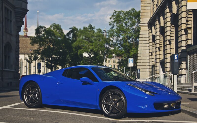 Blue Ferrari parked on city street