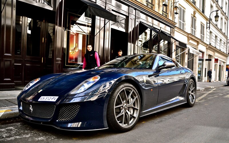 Blue Ferrari parked on city street