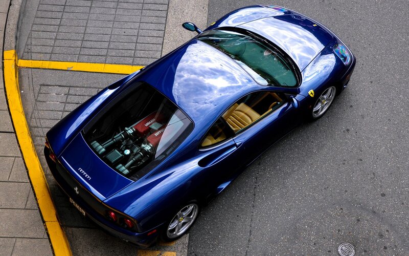 Blue Ferrari parked on street