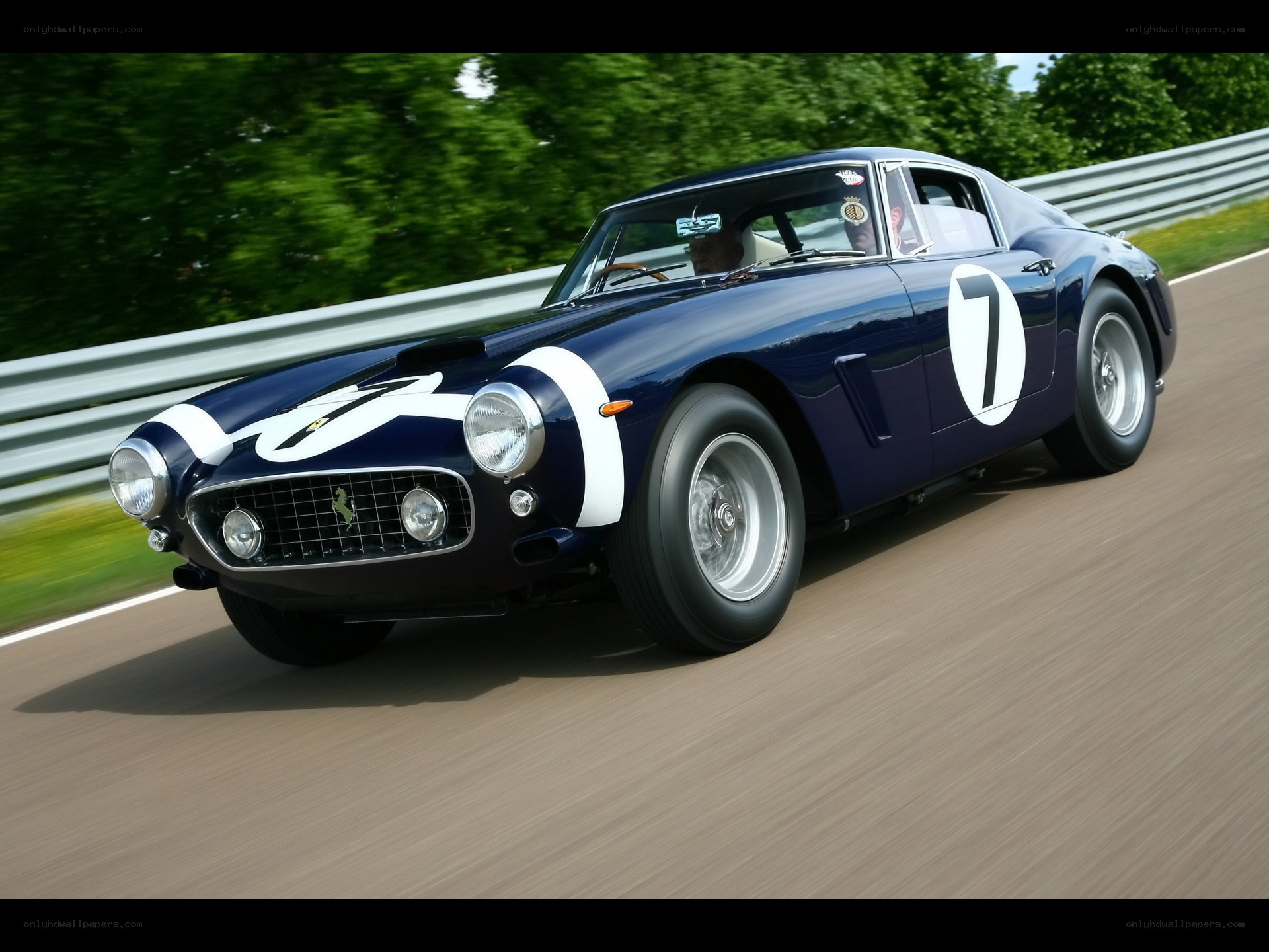 blue ferrari racing on track