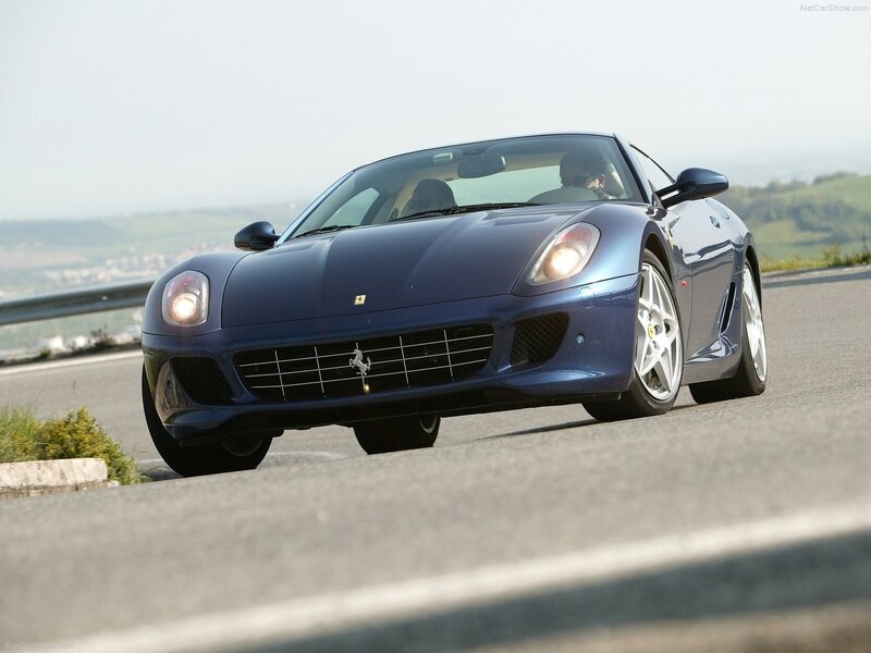 blue ferrari sports car on road