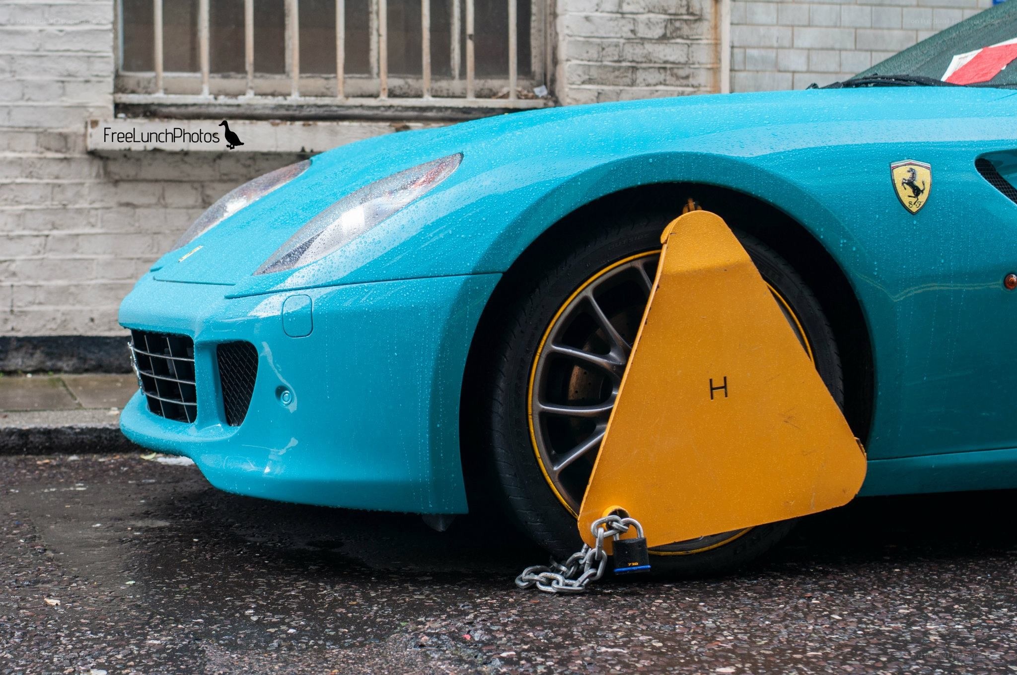 Blue Ferrari with wheel clamp