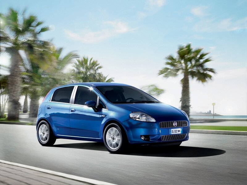 Blue Fiat Punto driving on a coastal road