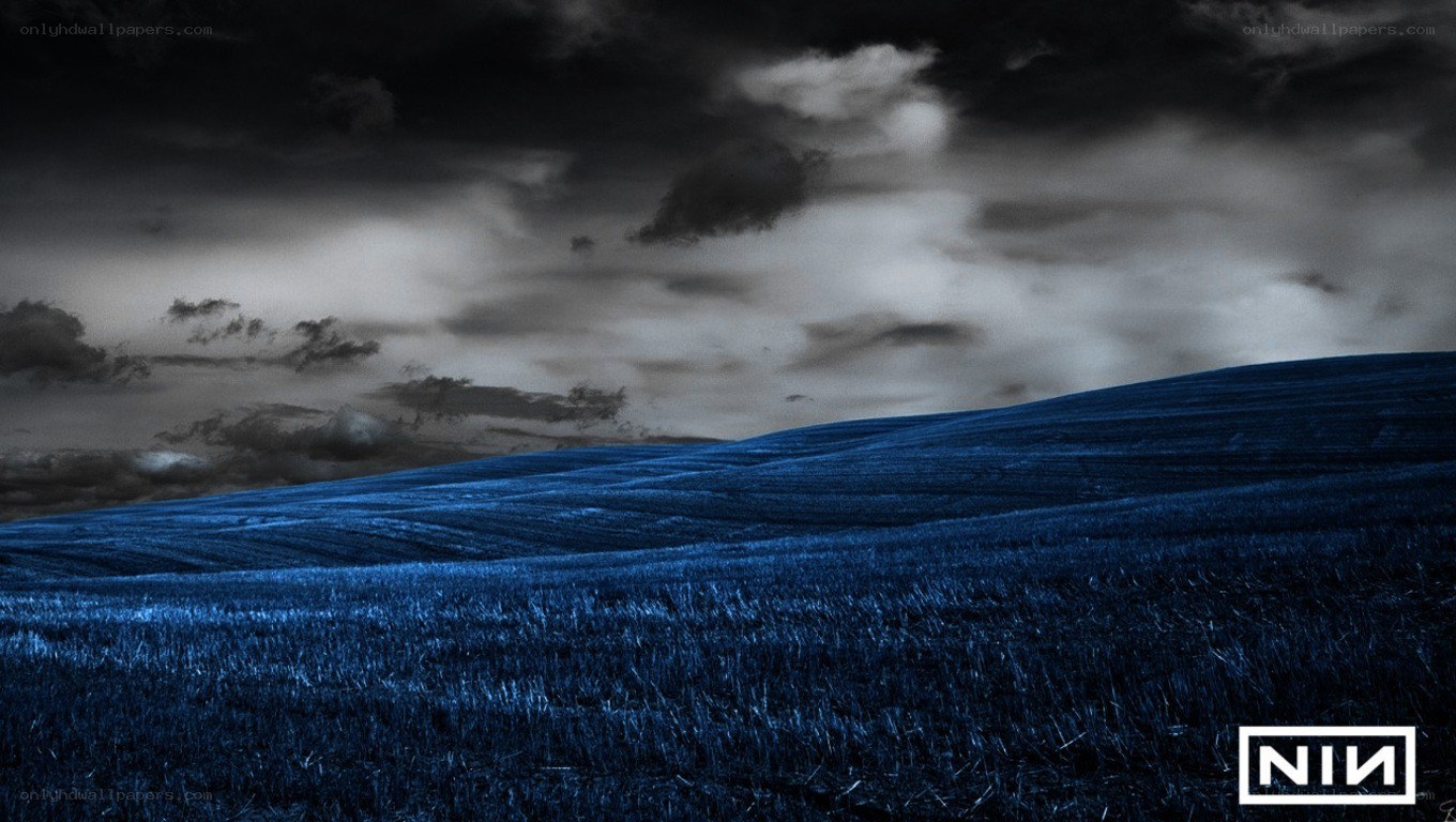 Blue field under stormy sky