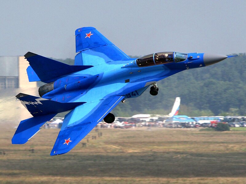Blue Fighter Jet — Dynamic, Afternoon, Photograph, Aircraft, Trees