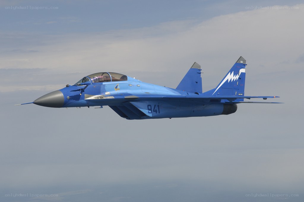 Blue fighter jet in flight
