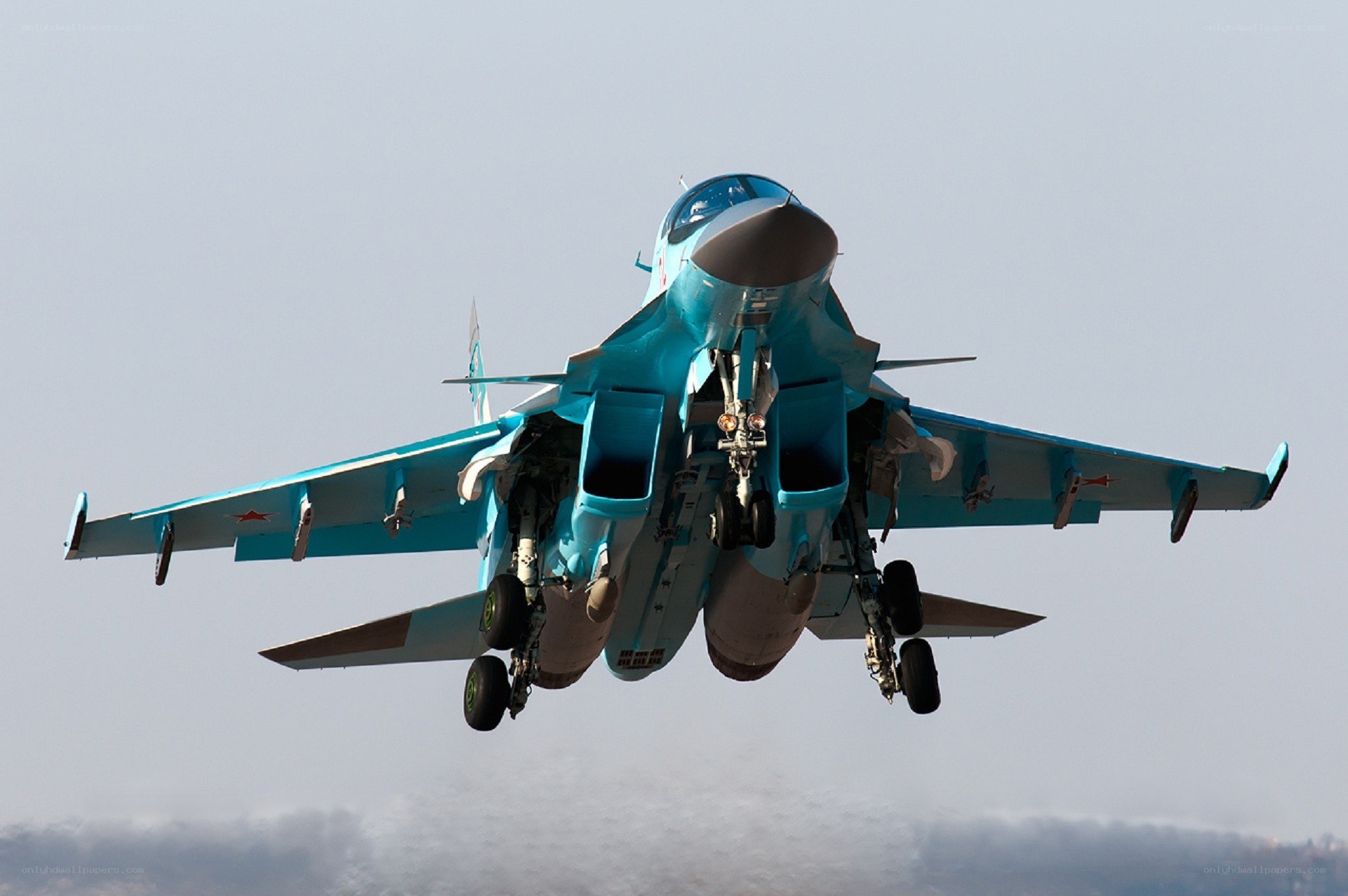 Blue fighter jet in flight