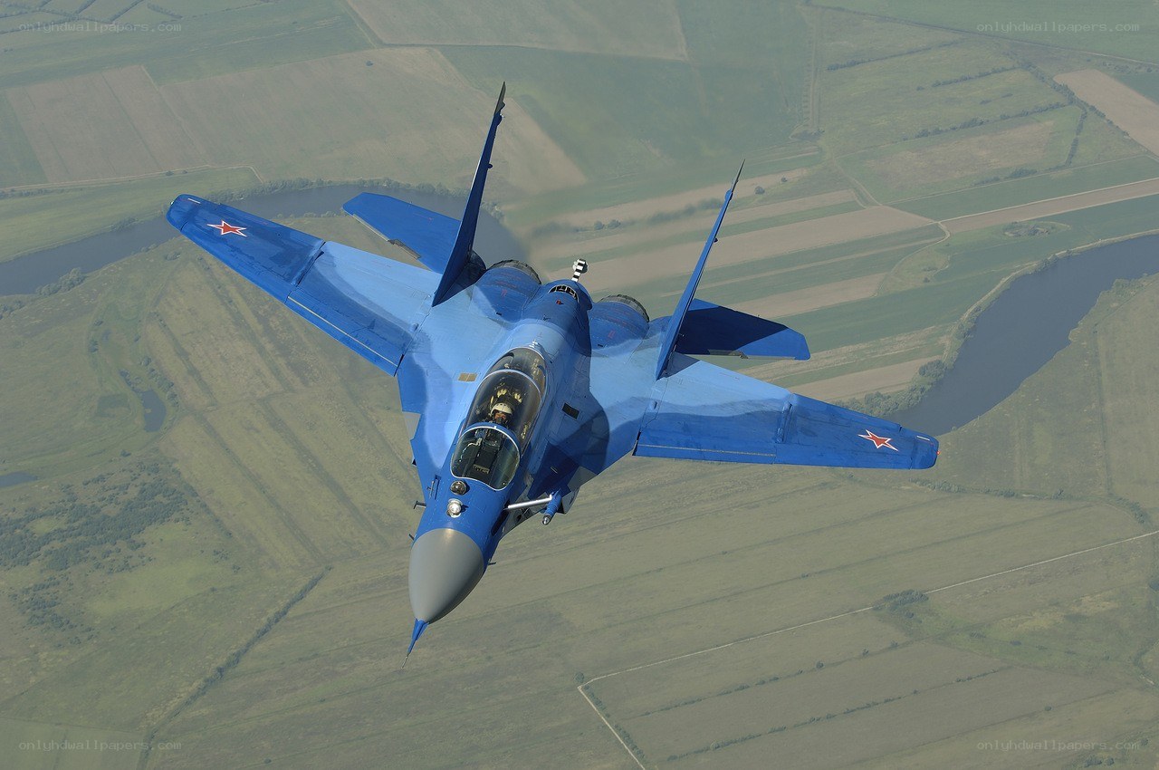 Blue fighter jet in flight