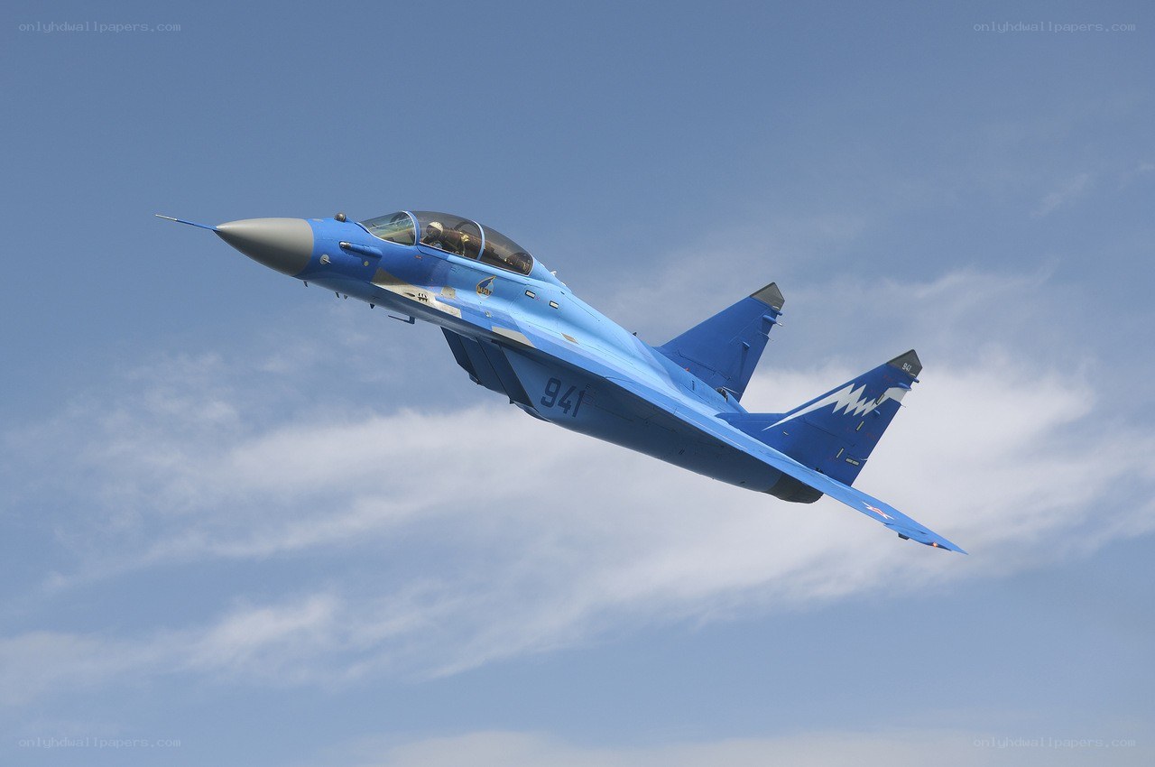 Blue fighter jet in flight