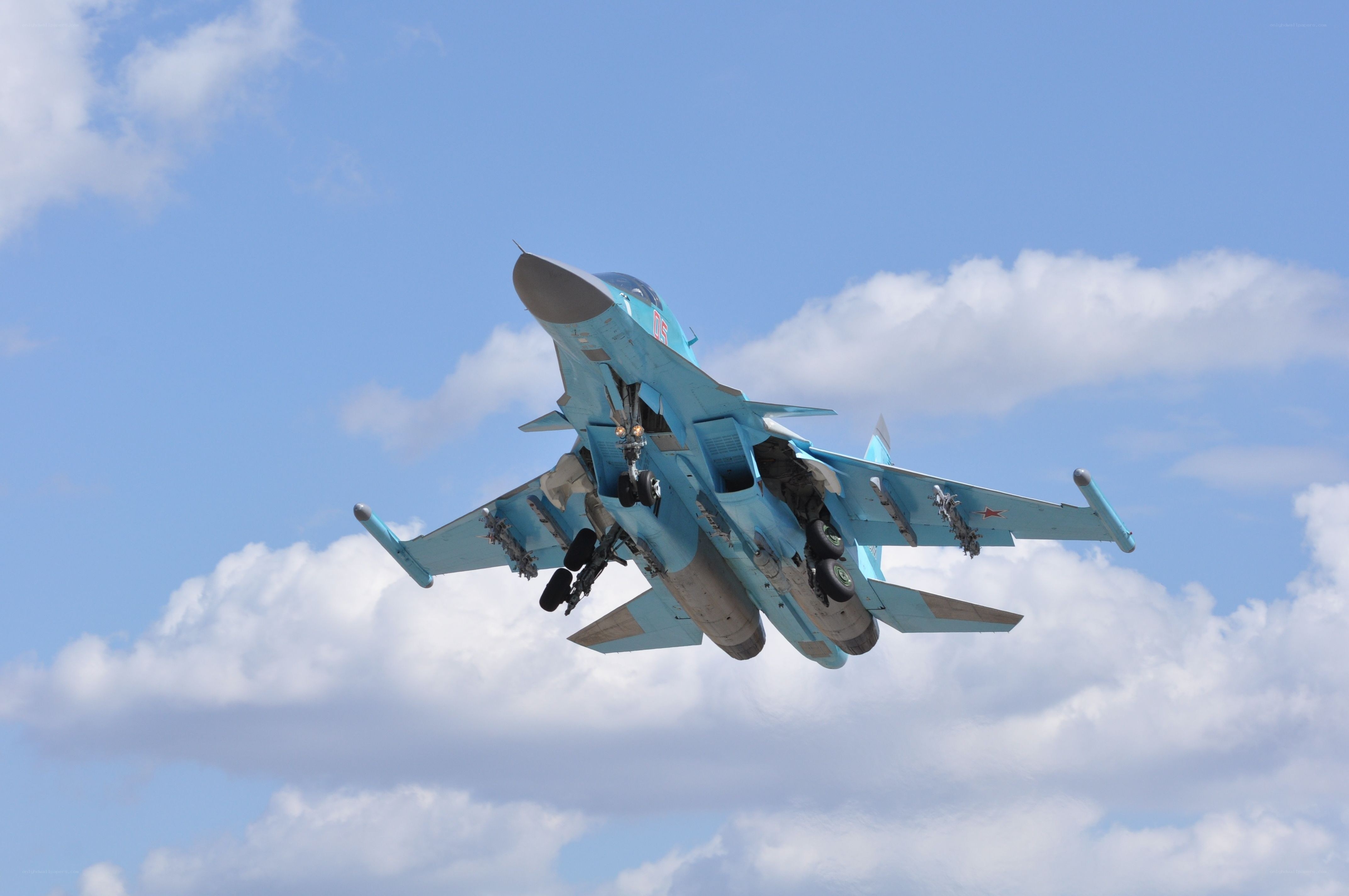 Blue fighter jet in flight