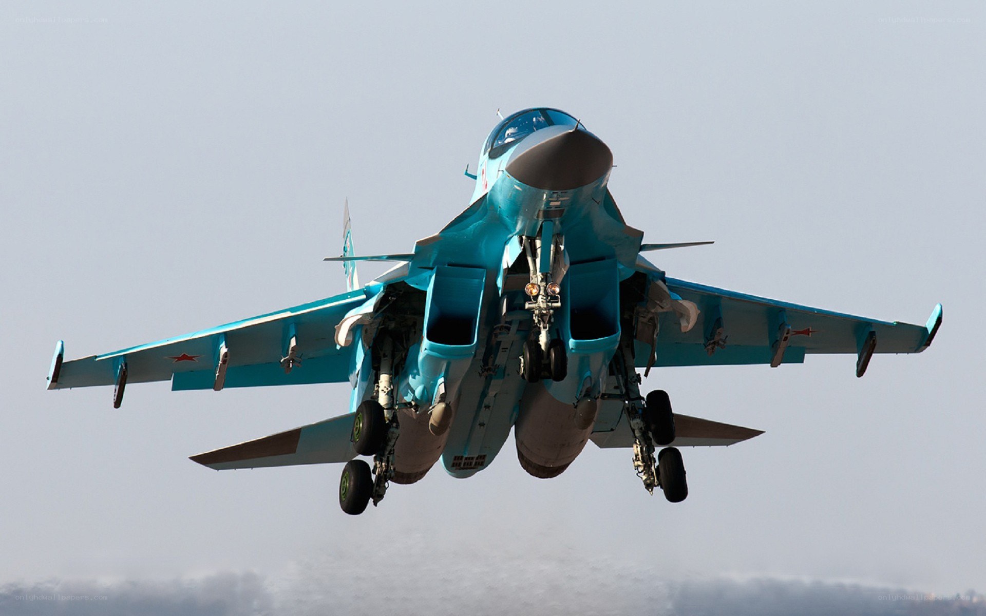 Blue fighter jet in flight