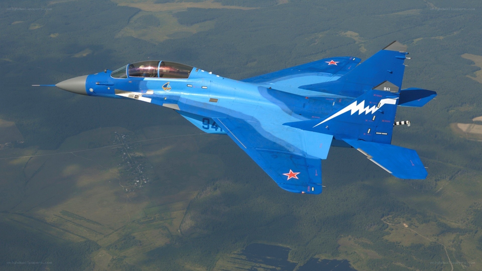 Blue fighter jet in flight