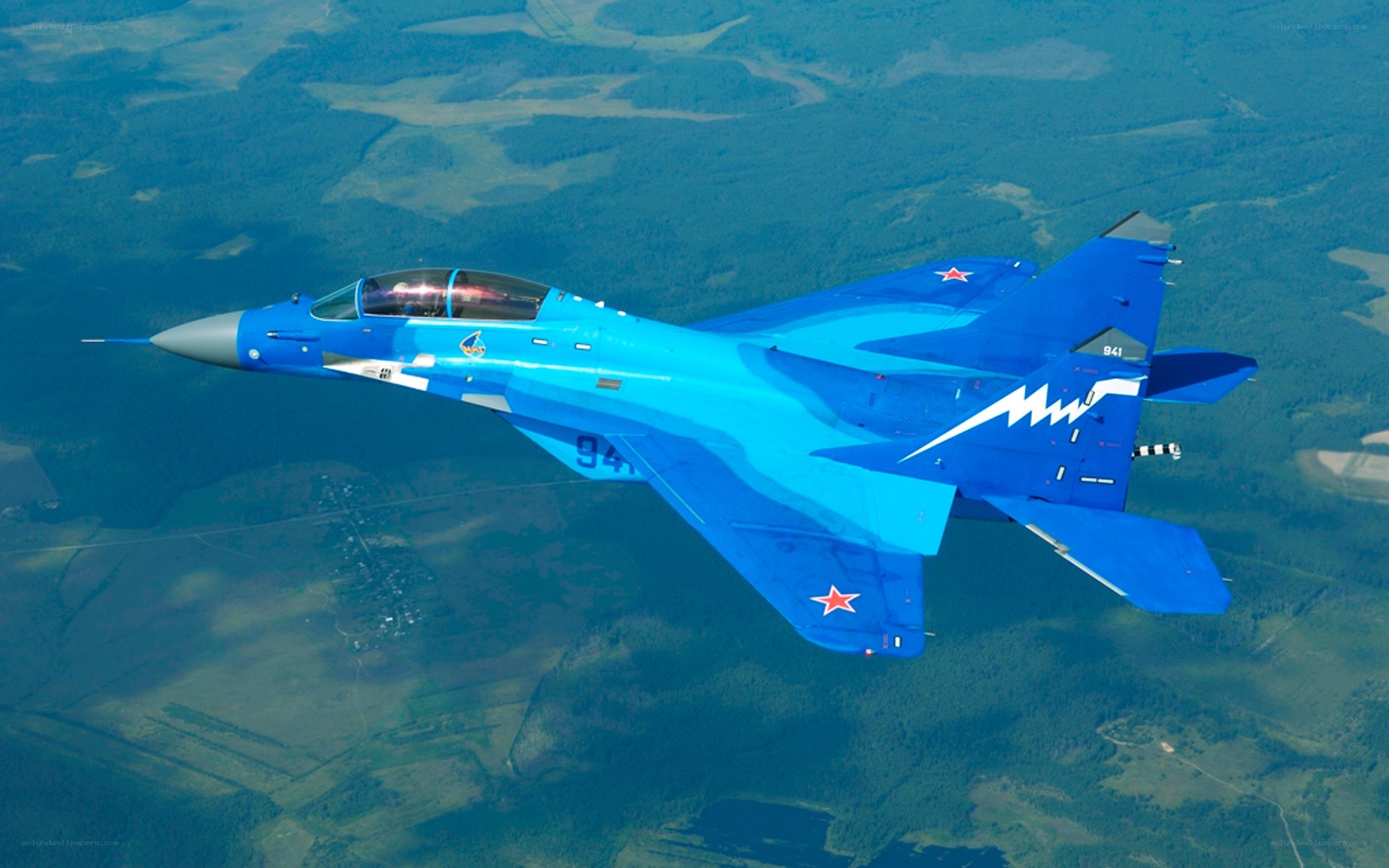 Blue fighter jet in flight