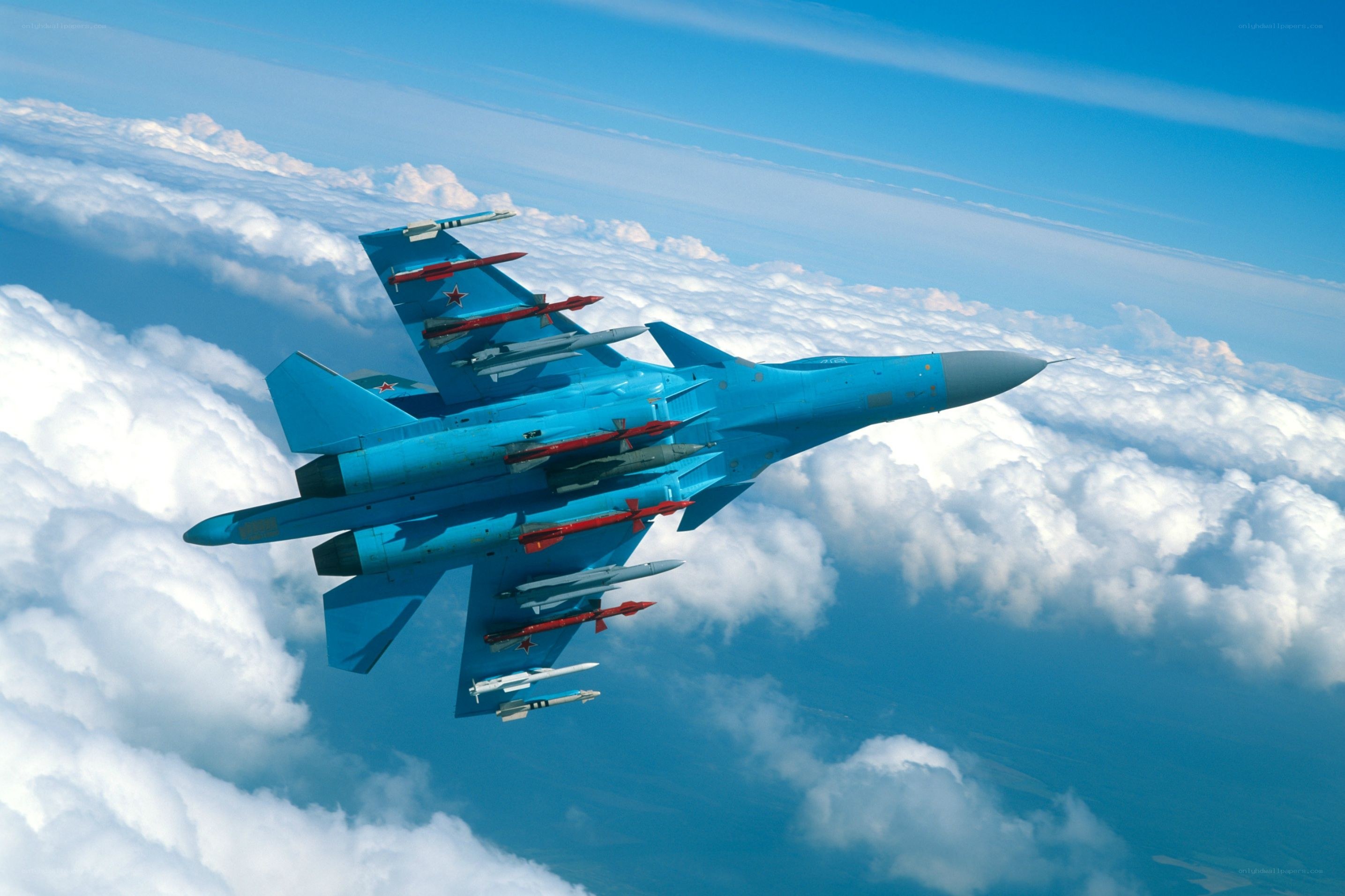 Blue fighter jet in flight