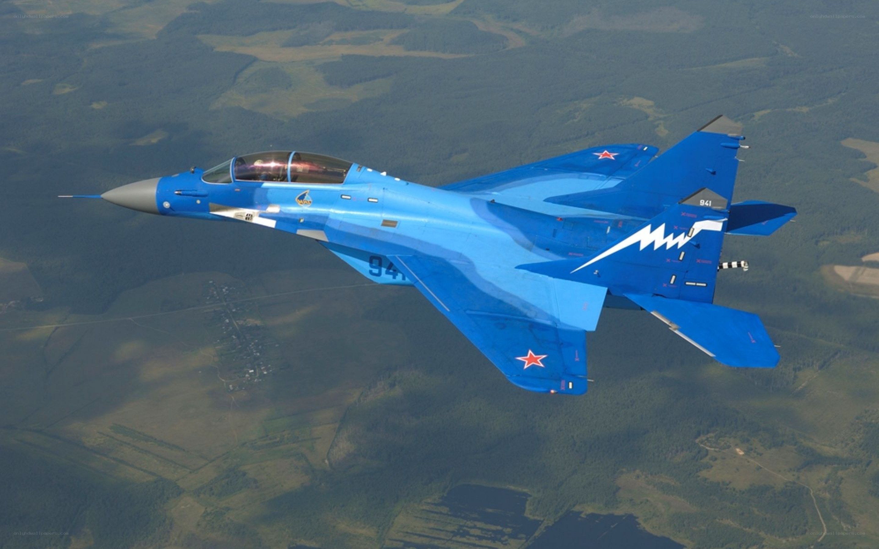 Blue fighter jet in flight