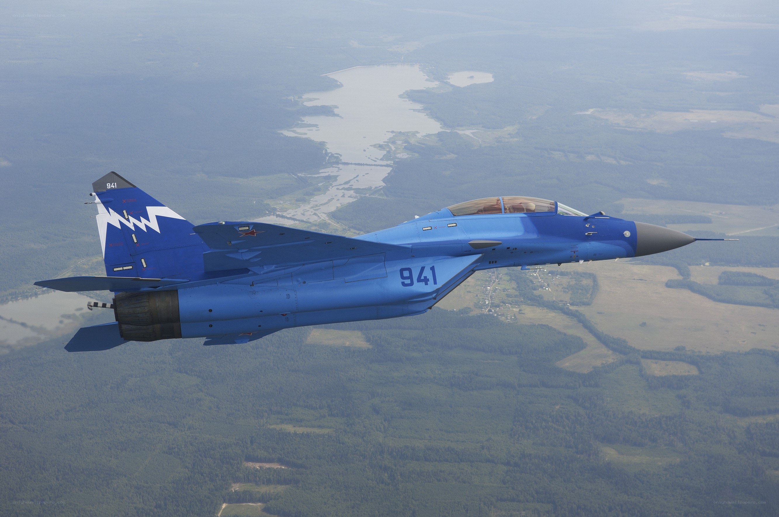 Blue fighter jet in flight