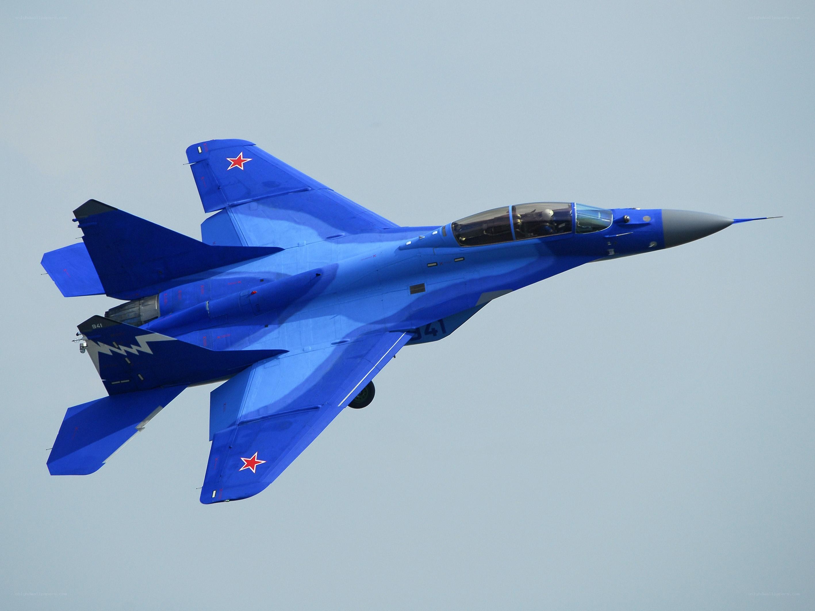 Blue fighter jet in flight