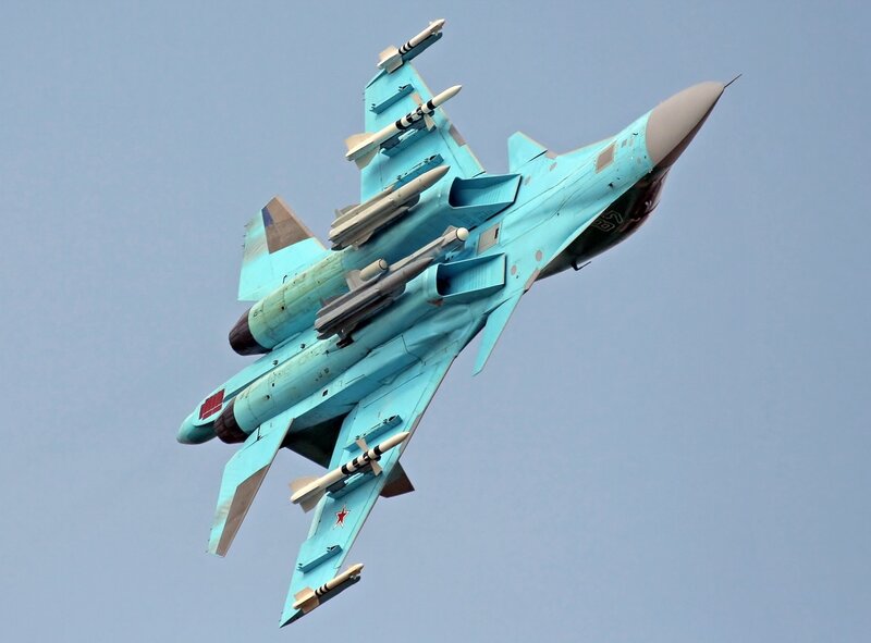 Blue fighter jet in flight