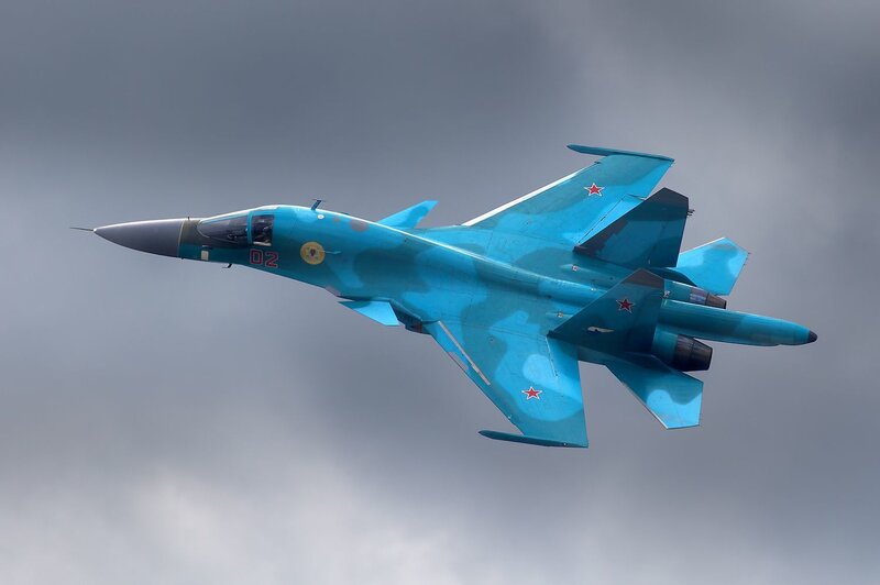 Blue fighter jet in flight