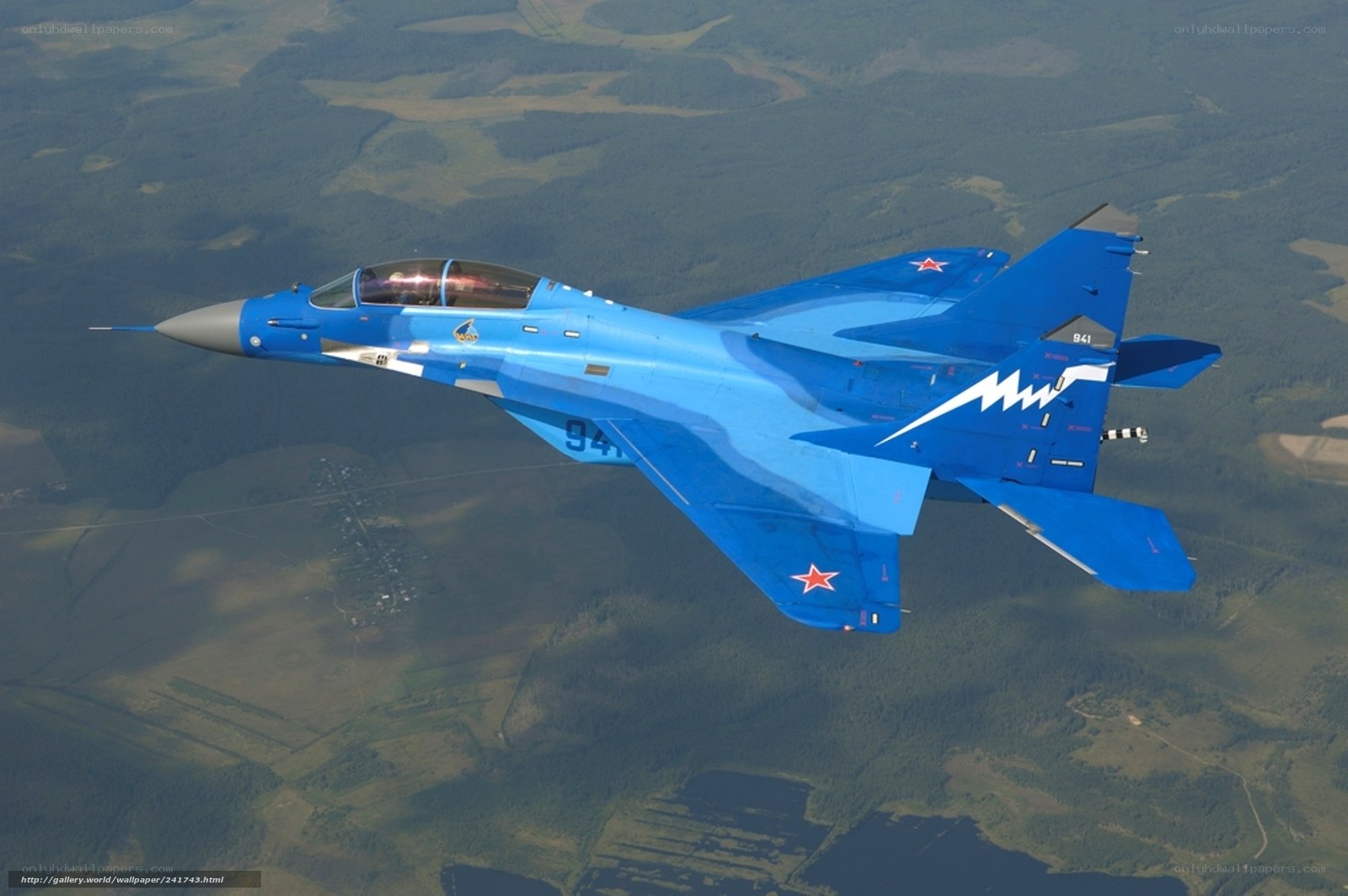 Blue fighter jet in flight