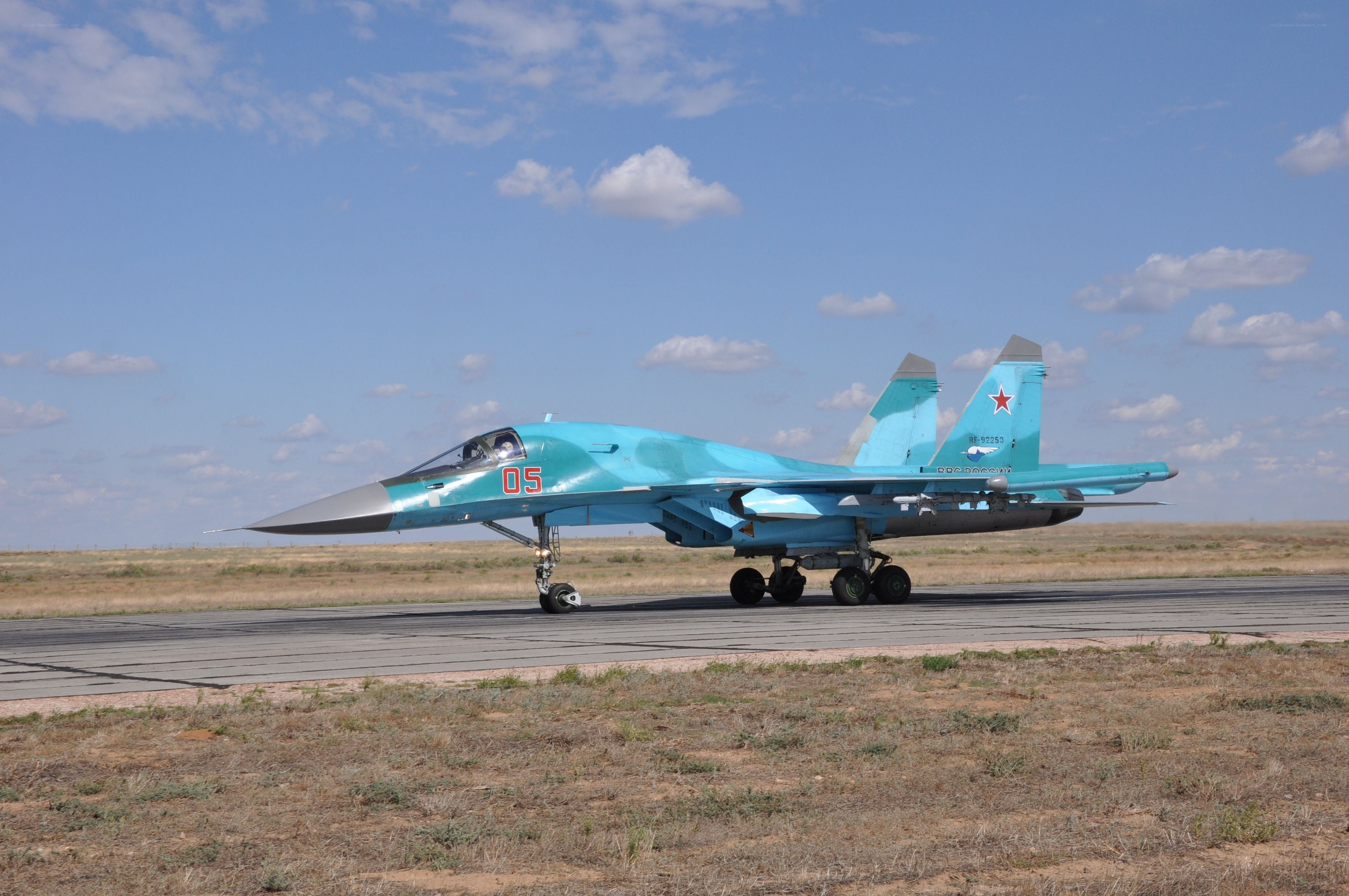 Blue fighter jet on runway