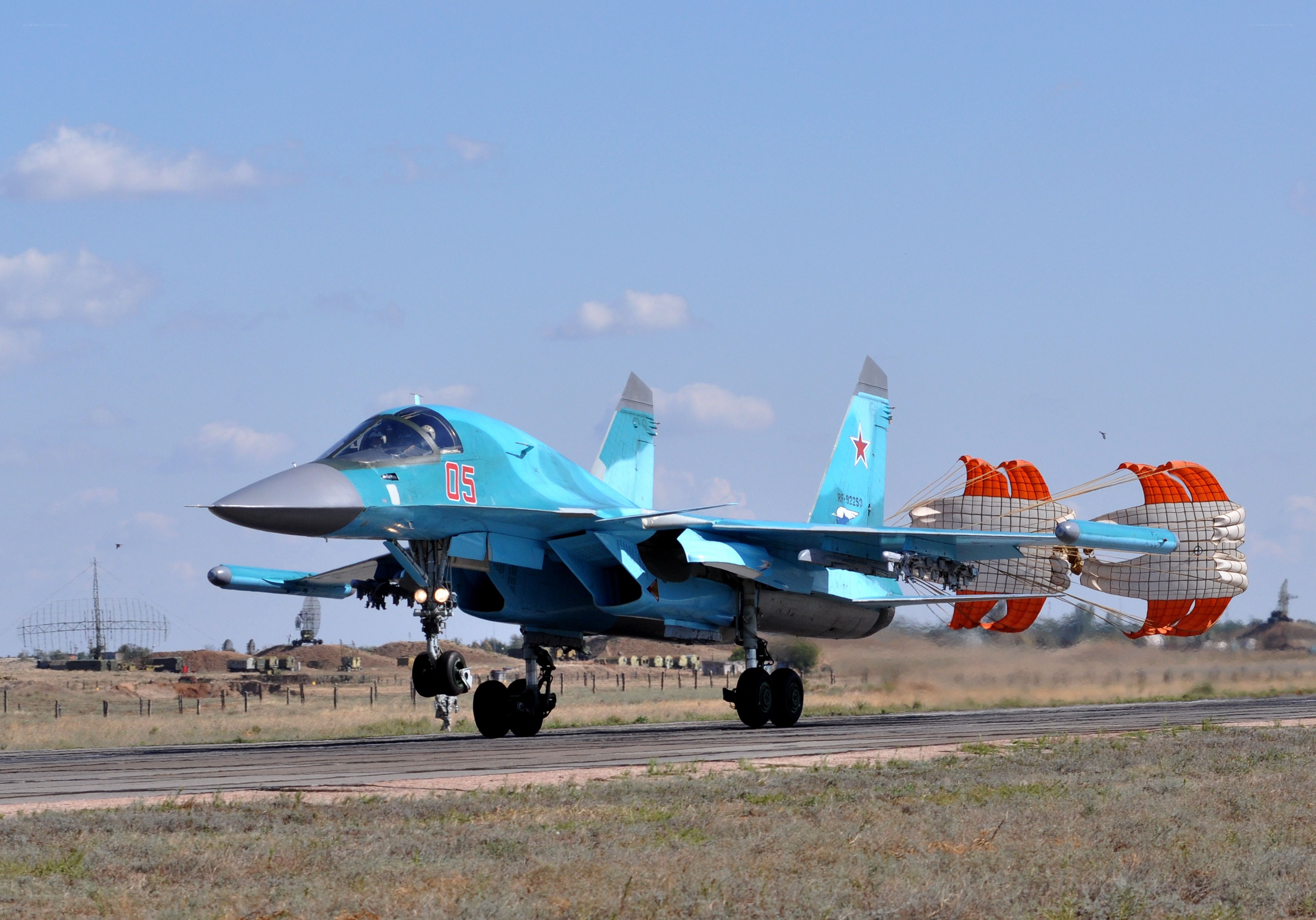 Blue fighter jet on runway