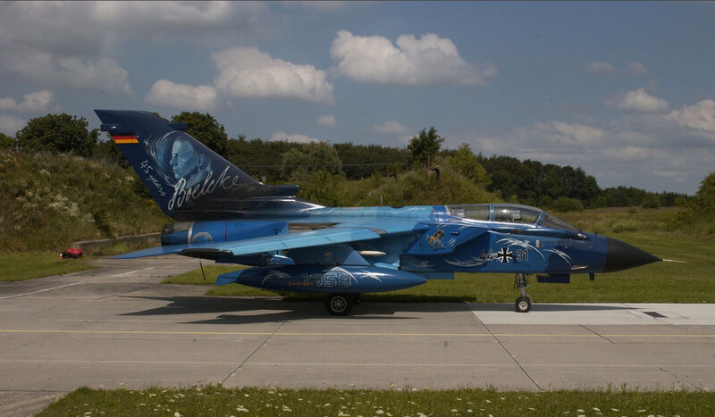 Blue fighter jet on tarmac