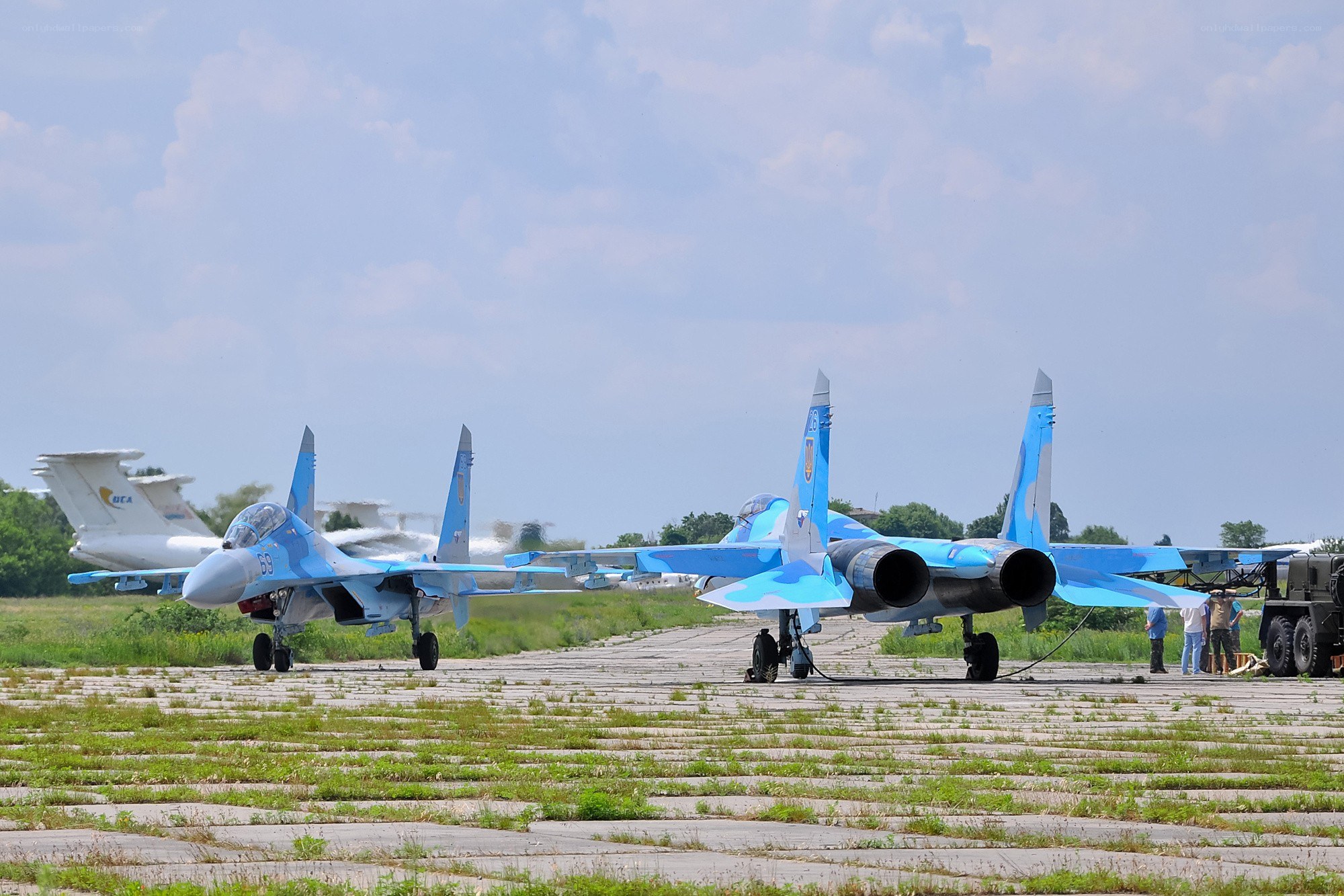 Blue fighter jets on tarmac