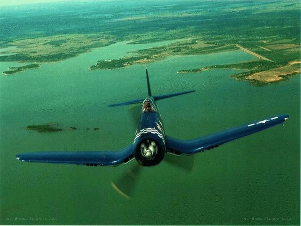 blue fighter plane over water