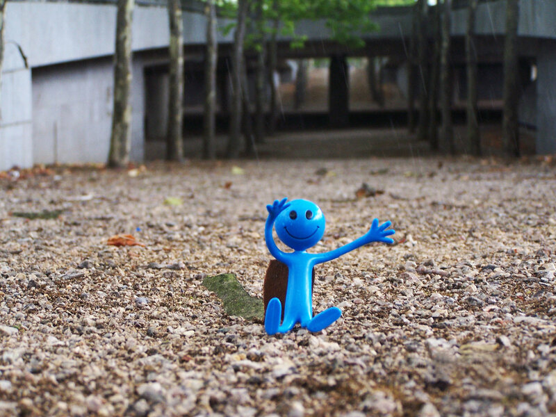Blue Figurine on Gravel