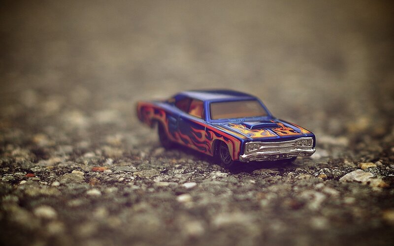 Blue flame toy car on gravel