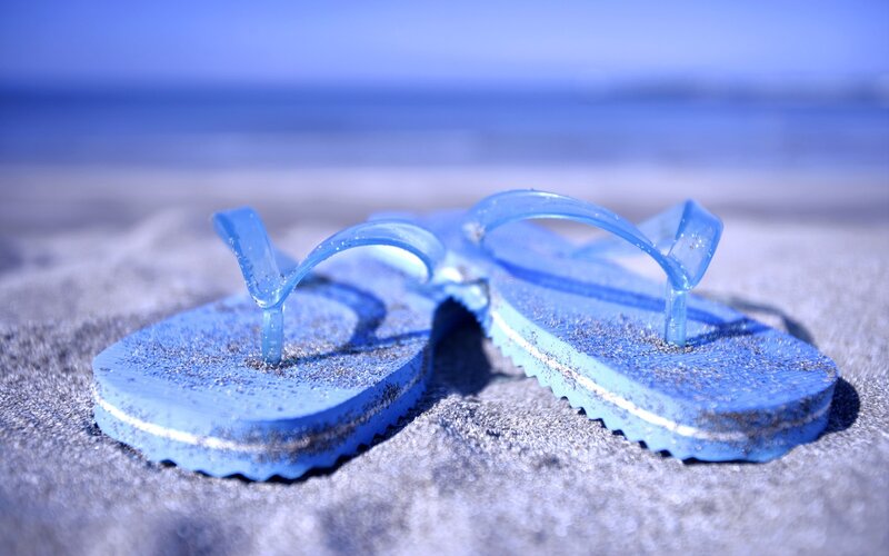 blue flip flops on beach