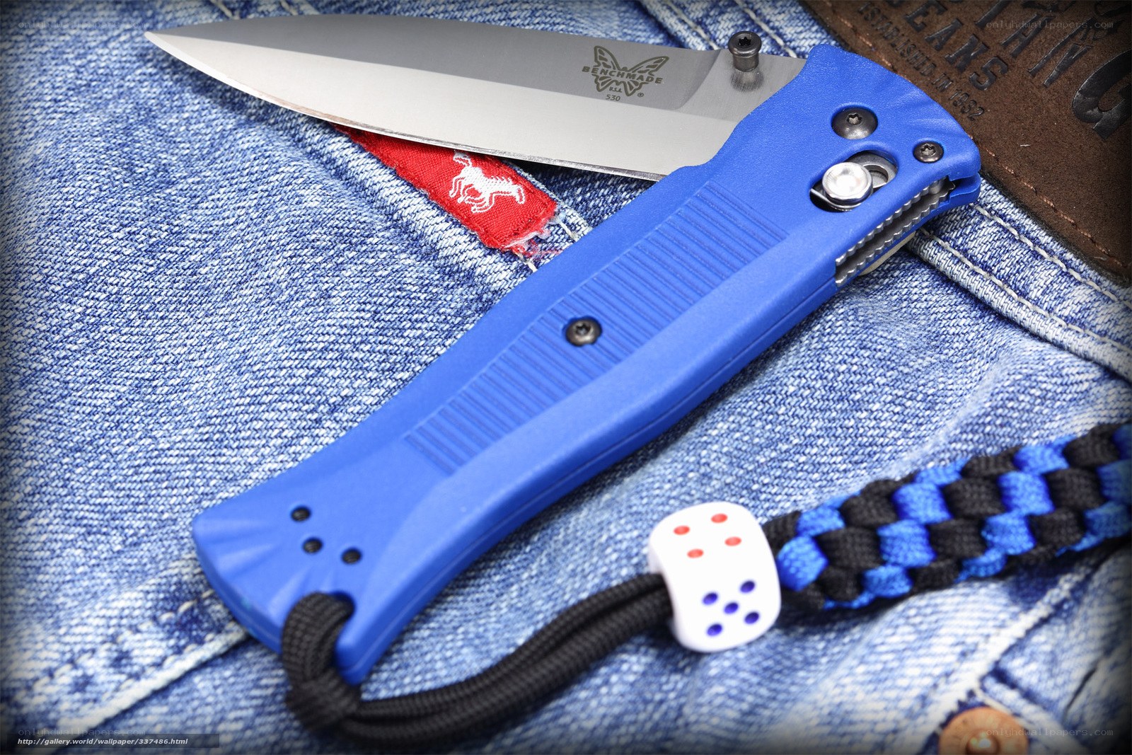 Blue folding knife on denim