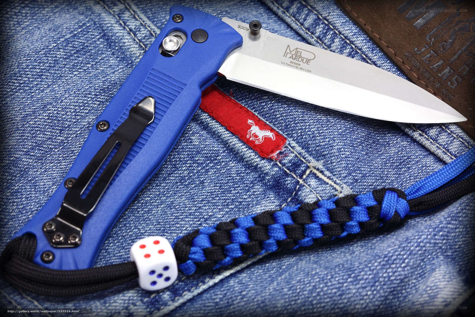 blue folding knife on jeans