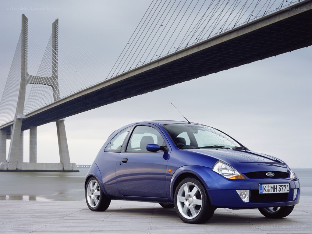 Blue Ford Ka under a bridge