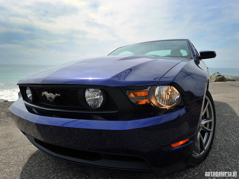 Blue Ford Mustang by the sea