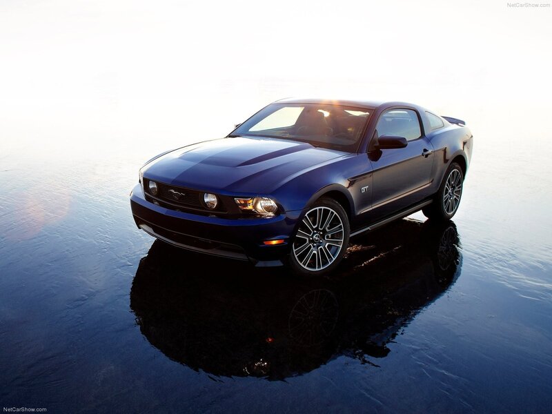 Blue Ford Mustang GT on wet surface