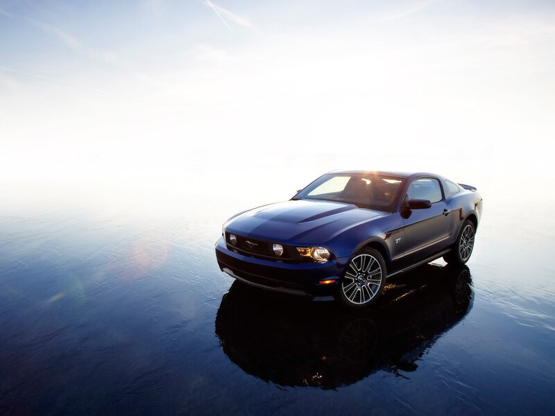 Blue Ford Mustang GT on wet surface