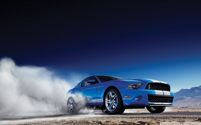Blue Ford Mustang GT performing burnout