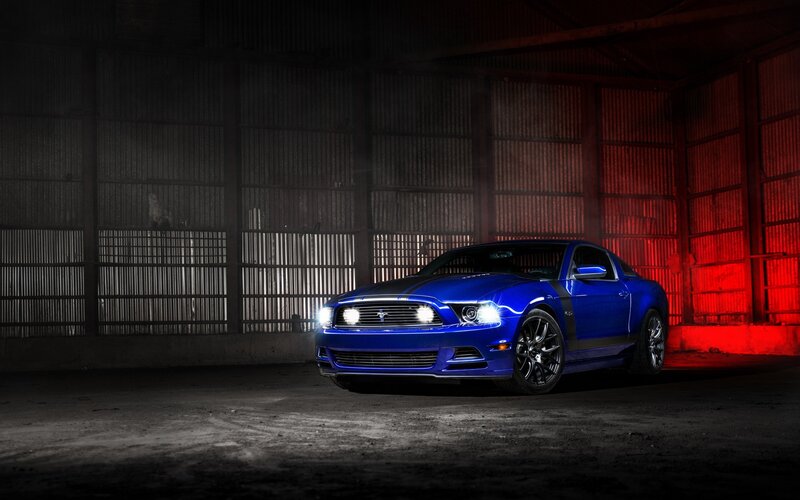Blue Ford Mustang in a warehouse